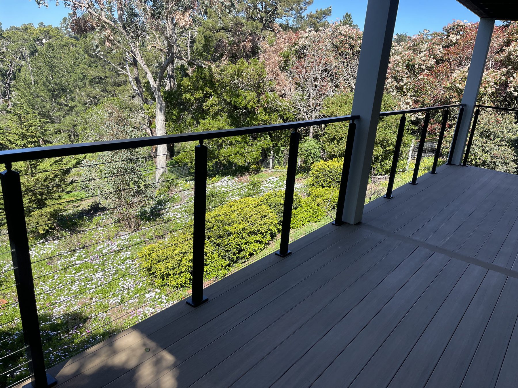 Composite deck with cable railing overlooking a Monterey County hillside